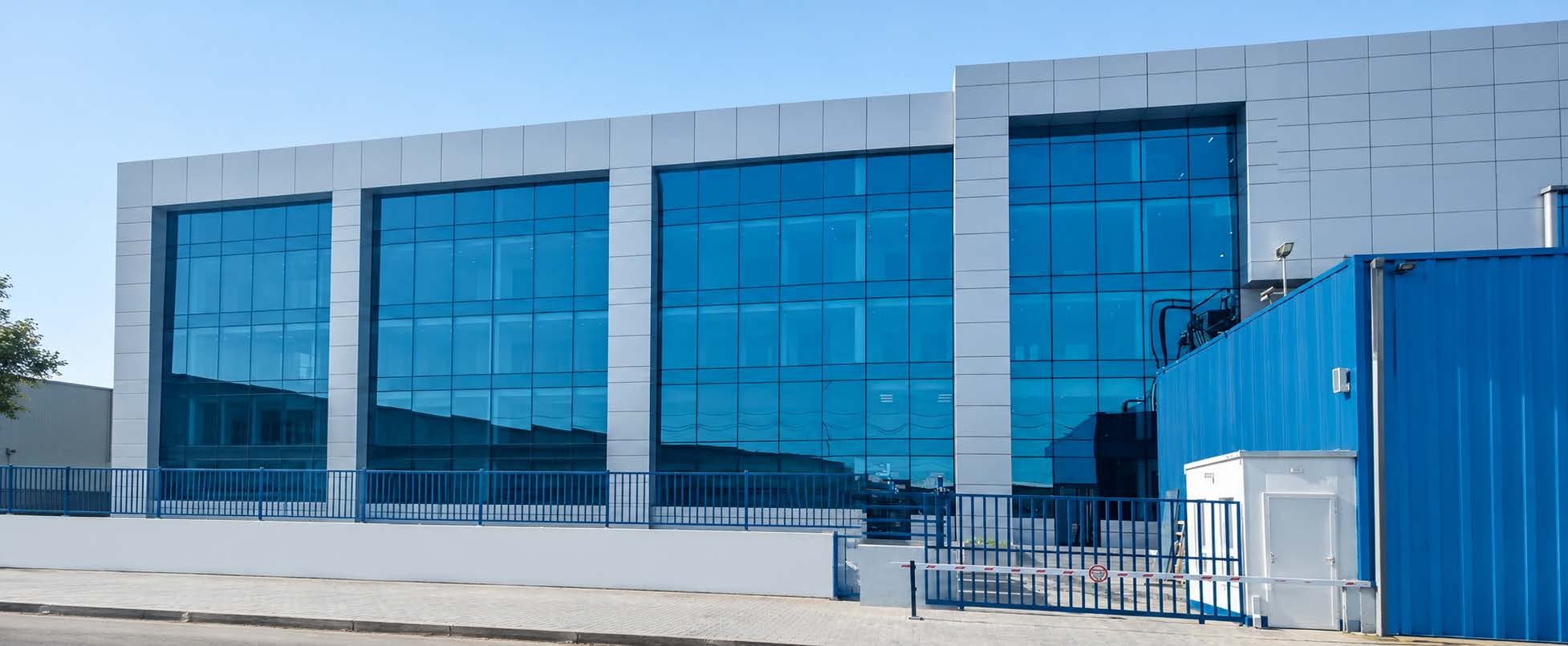Blue curtain-wall commercial building — MCC commercial buildings sector